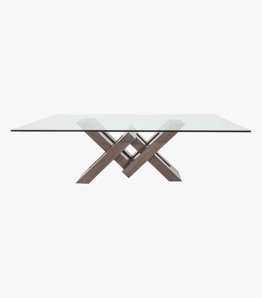 Mesa Vemer rectangular de Avanti Muebles con base de madera y cubierta de cristal, vista desde un lado sobre superficie blanca.